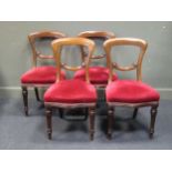 A set of four mid victorian mahogany chairs with craved 'C' scroll cross splats, the serpentine