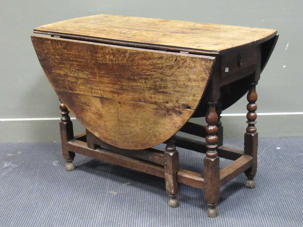 A 19th century oak gateleg table with single end drawer on turned legs 74 x 108 x 141cm open and