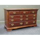 A reproduction Georgian style chest of drawers, comprising of seven drawers on bracket feet 79 x 139