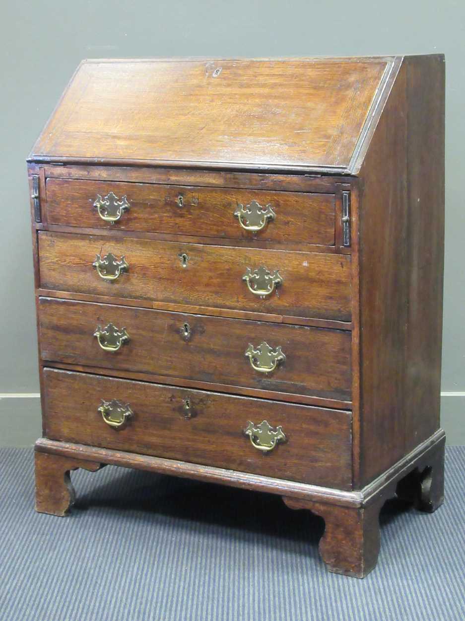 An oak fall front bureau with four graduated drawers 99 x 76 x 46cm