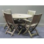A modern teak octagonal folding garden table 70 x 103 x 103cm together with four folding chairs (two