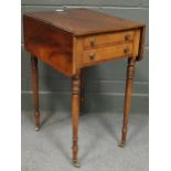 A Regency mahogany work table comprising of two drawers on slim turned legs and brass castors 69 x