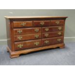A reproduction Georgian style chest of drawers, comprising of seven drawers on bracket feet 79 x 139