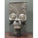 An African carved wood Batchum style shoulder mask on later stand 103 x 56 x 31cm