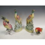A pair of Staffordshire flat back models of birds; a continental porcelain model of a parrot and a