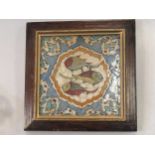 A Persian tile decorated with three fish, 19.5 x 19.5cm