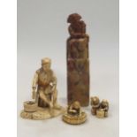 An ivory Oni okimono, signed; an ivory sectional okimono of a fisherman, and an ivory okimono of