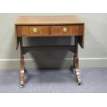 An Edwardian George III revival crossbanded mahogany sofa table the rising leaves over two frieze