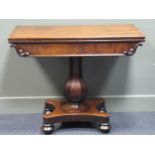 Circa 1840 a mahogany fold over swivel top table with carved mouldings on a chamfered bulbous column