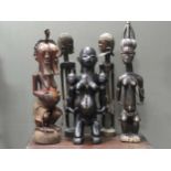 A Songye double faced figure 90.5cm high, a Makonde sewn wood maternity figure holding two