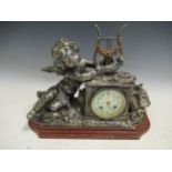 A French metal mantle clock with a porcleain dial, on a rouge griotte baseCondition report: 29.5cm