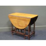 An oak gateleg table on barley twist supports