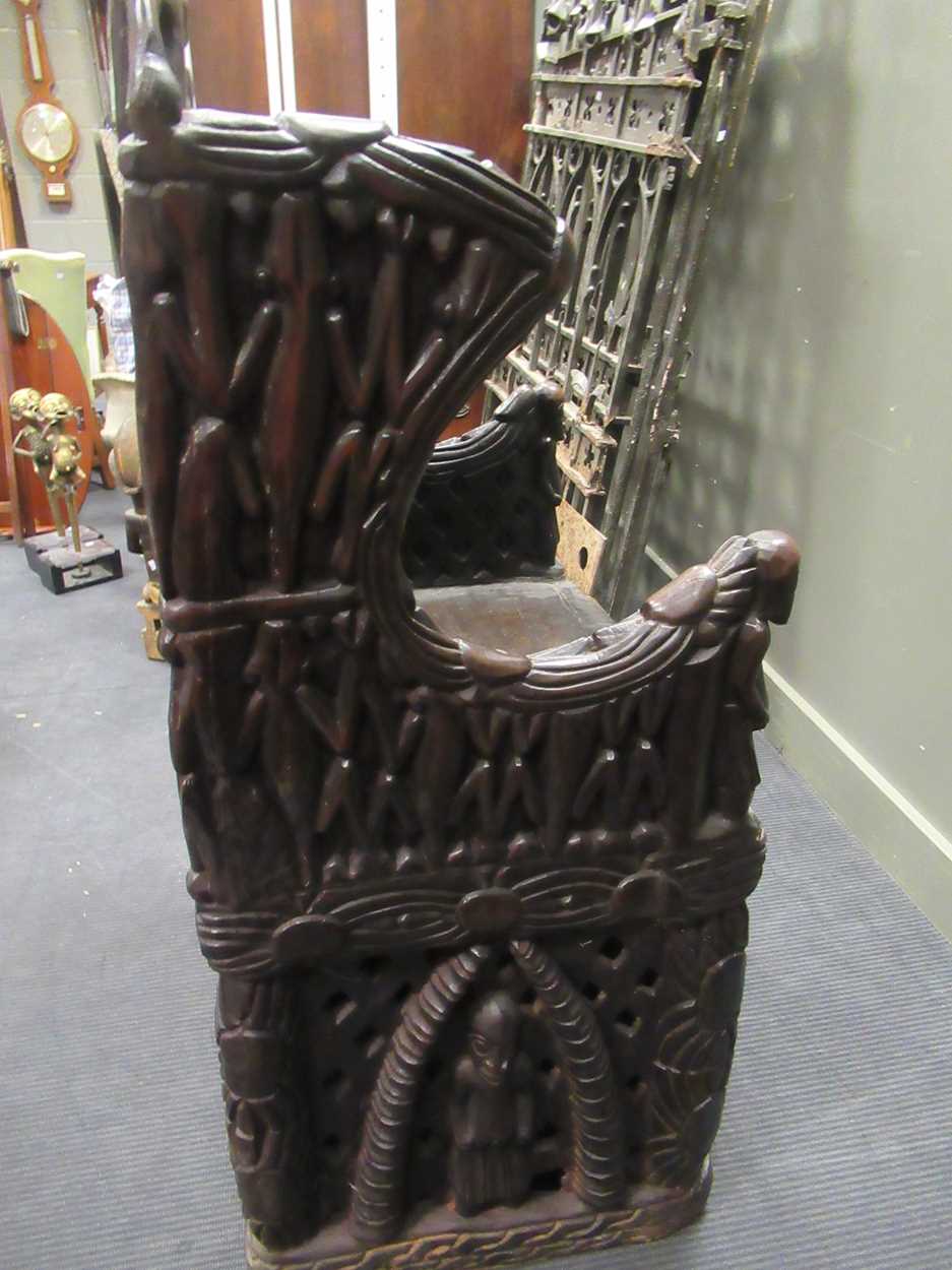 A Bamileke throne chair, profusely carved with animals, patterns and figures 140 x 70 x 55cm - Image 5 of 7