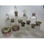 A collection of glass scent bottles some silver mounted