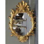 A giltwood mirror, with acanthus cresting and acanthus moulded frame, 107cm high and 74cm wide