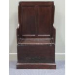 An 18th century hall settle the panelled back over a lift up seat on later plinth base 116 x 66 x
