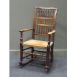 A rush seated stick back rocking chair 108cm high