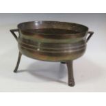 A Swedish two-handled bronze bowl on three feet, inscribed 'OA 1771', 41cm wide over handles