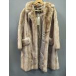 A three quarter length satin lined fur coat retailed by Jenners of Edinburgh size 14