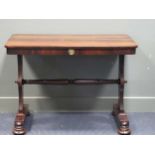 A circa 1830 rosewood library table with single frieze drawer on bun feet and brass castors, 72 x