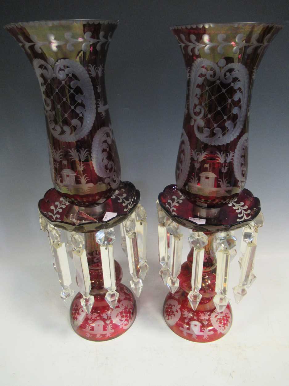 A pair of red glass candle lustres, 45cm high