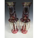 A pair of red glass candle lustres, 45cm high