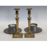 A pair of 18th century peweter inkwells and a pair of George III brass candlesticks