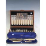 A cased set of twelve bone fish knives and forks, with silver blades and tines; a cased set of