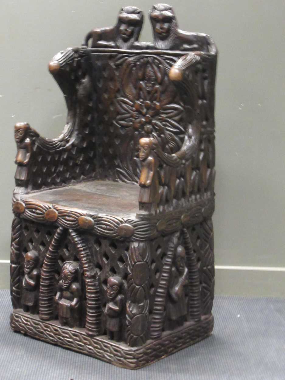 A Bamileke throne chair, profusely carved with animals, patterns and figures 140 x 70 x 55cm