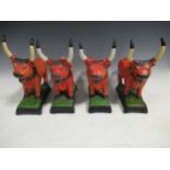 A set of pottery bulls, painted in orange on rectangular bases, 28cm high (4)