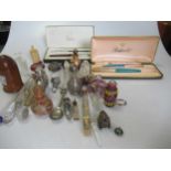 Four cased Parker pens together with a collection of mostly glass scent bottles