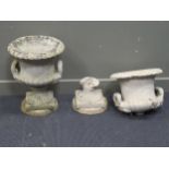 A pair of composite stone two handled campana shaped urns on pedestal bases (one A/F) 58cm high