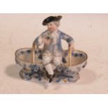 A Meissen sweetmeat figural basket, crossed swords mark