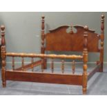 A modern bed with arched head board and turned frame 141 x 164 x 214cm