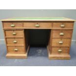 A pine pedestal desk comprising of nine drawers with brass cup handles 78 x 129 x 68cm