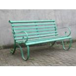 A green painted garden bench with wooden slats and scrolling end supports 153cm wide