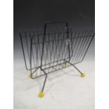 A 1970's Atomic style wirework magazine rack on four yellow ball feet