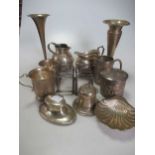 A collection of silverware including christening tankards, cream jugs, toast racks, bud vases,