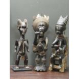 A Yombe figure of a fisherman 70cm high together with a Dan female tribal figure 62cm high and a