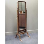 A 20th century walnut cheval mirror on four shell carved cabriole legs 163cm high and 50cm
