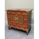 A 20th century Chinese brass bound side cabinet comprising of four drawers above two cupboard doors,