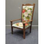 An early 20th century tapestry upholstered oak arm chair