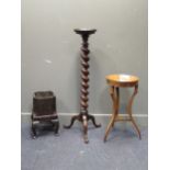 A 19th century mahogany torchere, the circular top above a barley twist column support on three