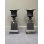 A pair of cast iron campagna garden urns, 86 x 40 cm