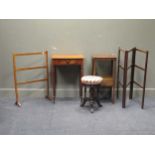 An Edwardian mahogany piano stool, a mahogany three fold colthes rail, a towel rail, a mahogany