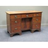 A 19th century mahogany dressing table, the rectangular top above seven drawers with a central