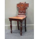 A William IV carved mahogany and inlaid hall chair, with scrolled back, and a corner washstand,
