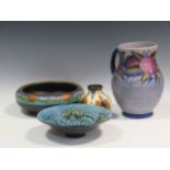A Charlotte Rhead jug, a Gouda vase, a Gouda bowl and a studio pottery bowl decorated with a fish (