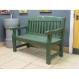 A green painted garden bench 94 x 123 x 62cmProvenance:Landwade Hall, Exning, Suffolk