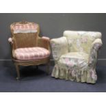 A French gilt wood bergere chair together with an Edwardian armchair with floral cover (2)